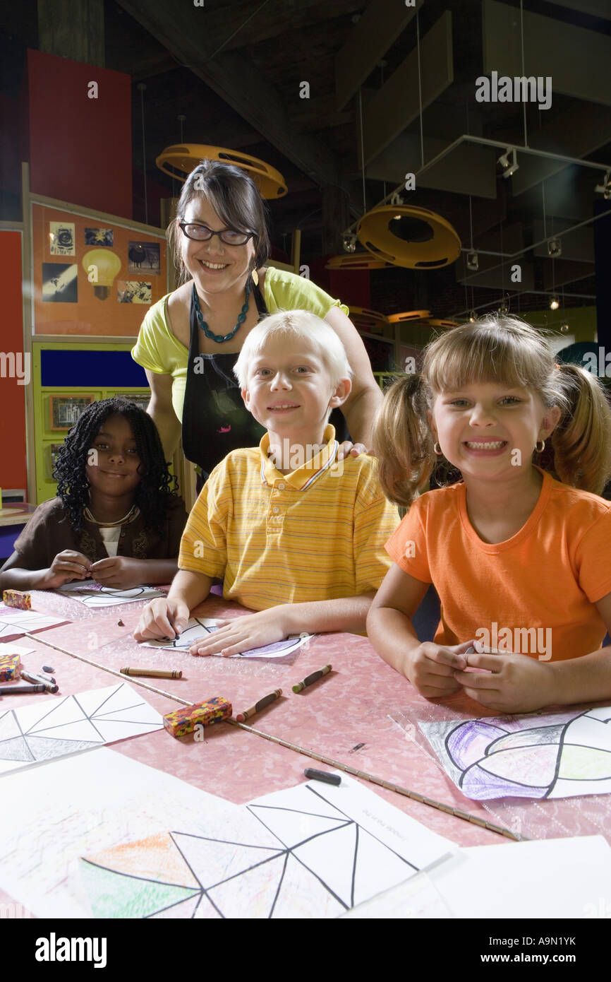 An art teacher teaching her young students in art class Stock Photo Alamy
