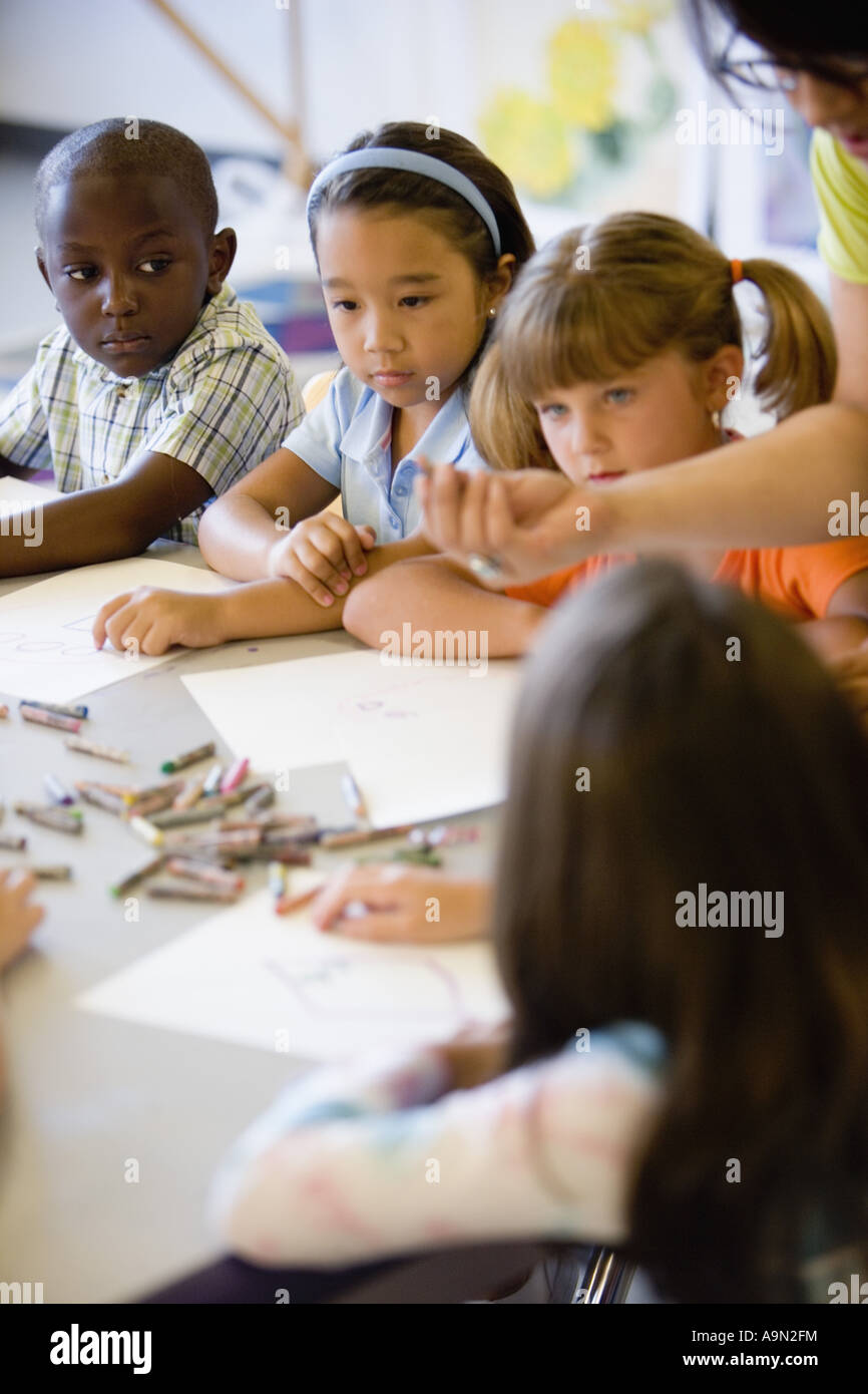 Boy and girls paying attention to teacher in an art class Stock Photo ...