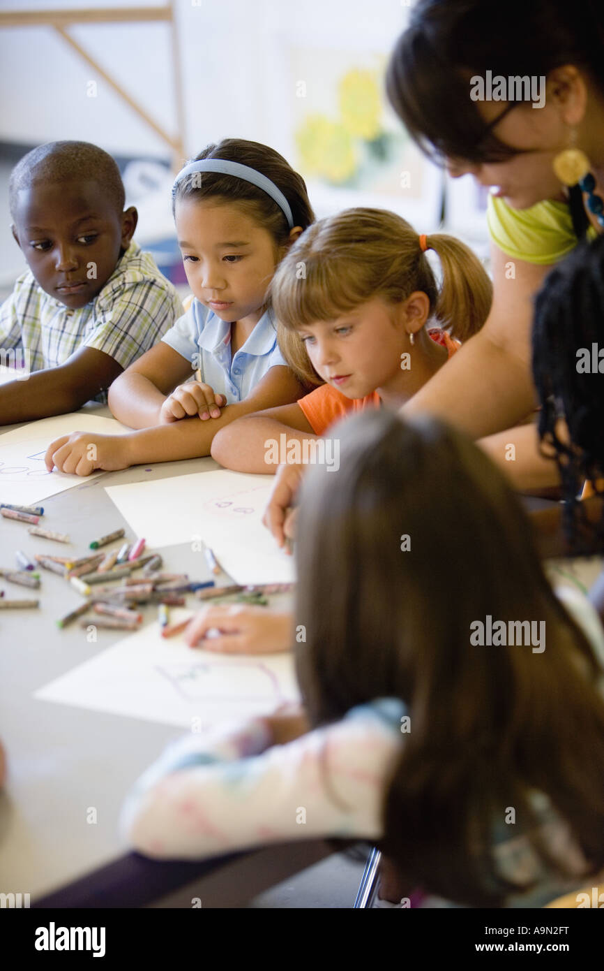 Boy and girls paying attention to teacher in an art class Stock Photo ...