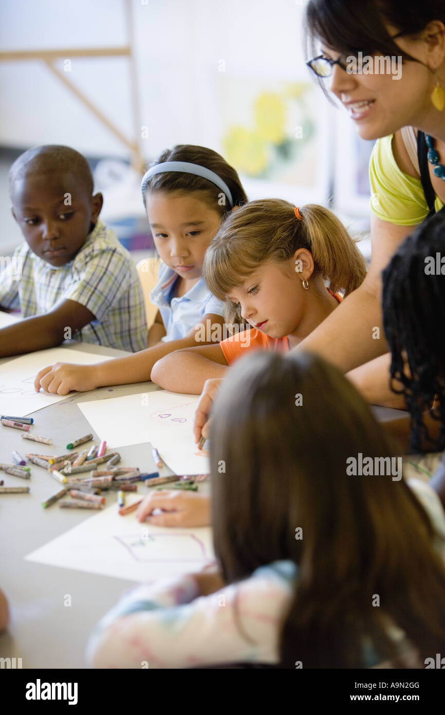 Boy and girls paying attention to teacher in an art class Stock Photo ...