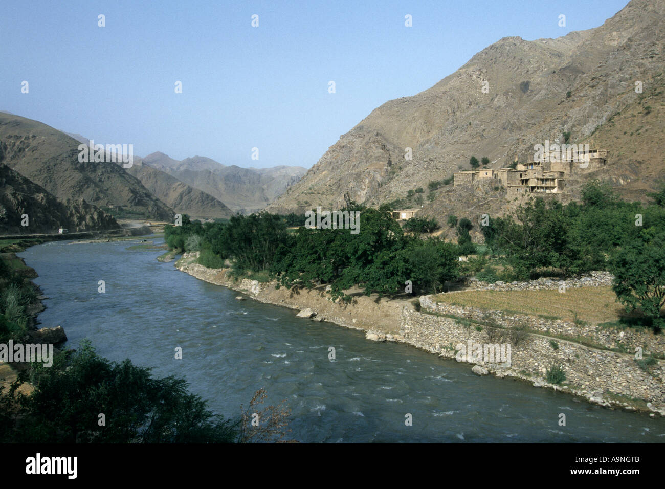 Afghanistan, province Parwan, Ghorband valley On the right basic houses built in the mountainside Stock Photo