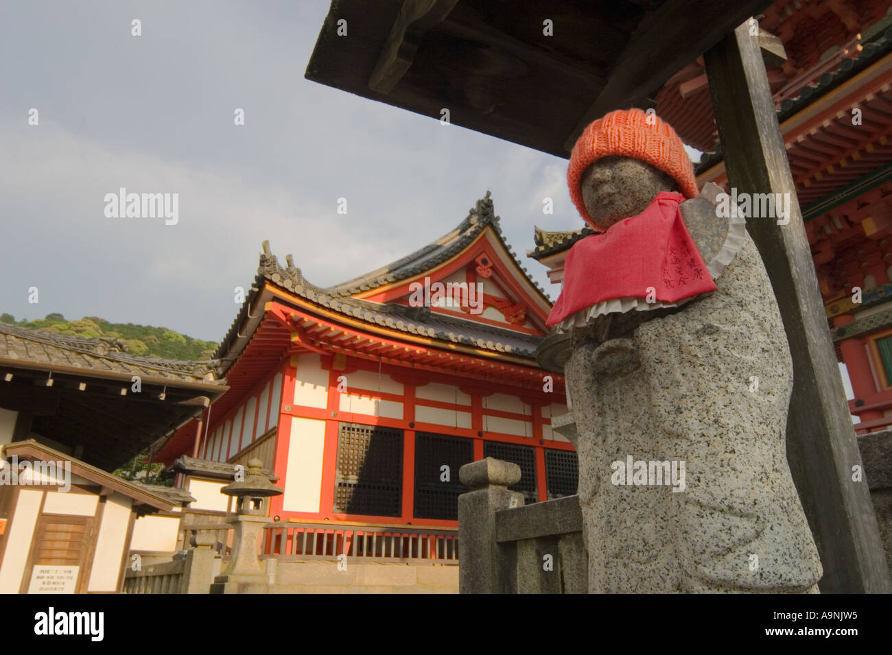 Jizo statue wearing an orange hat and bib at Kiyomizudera Temple