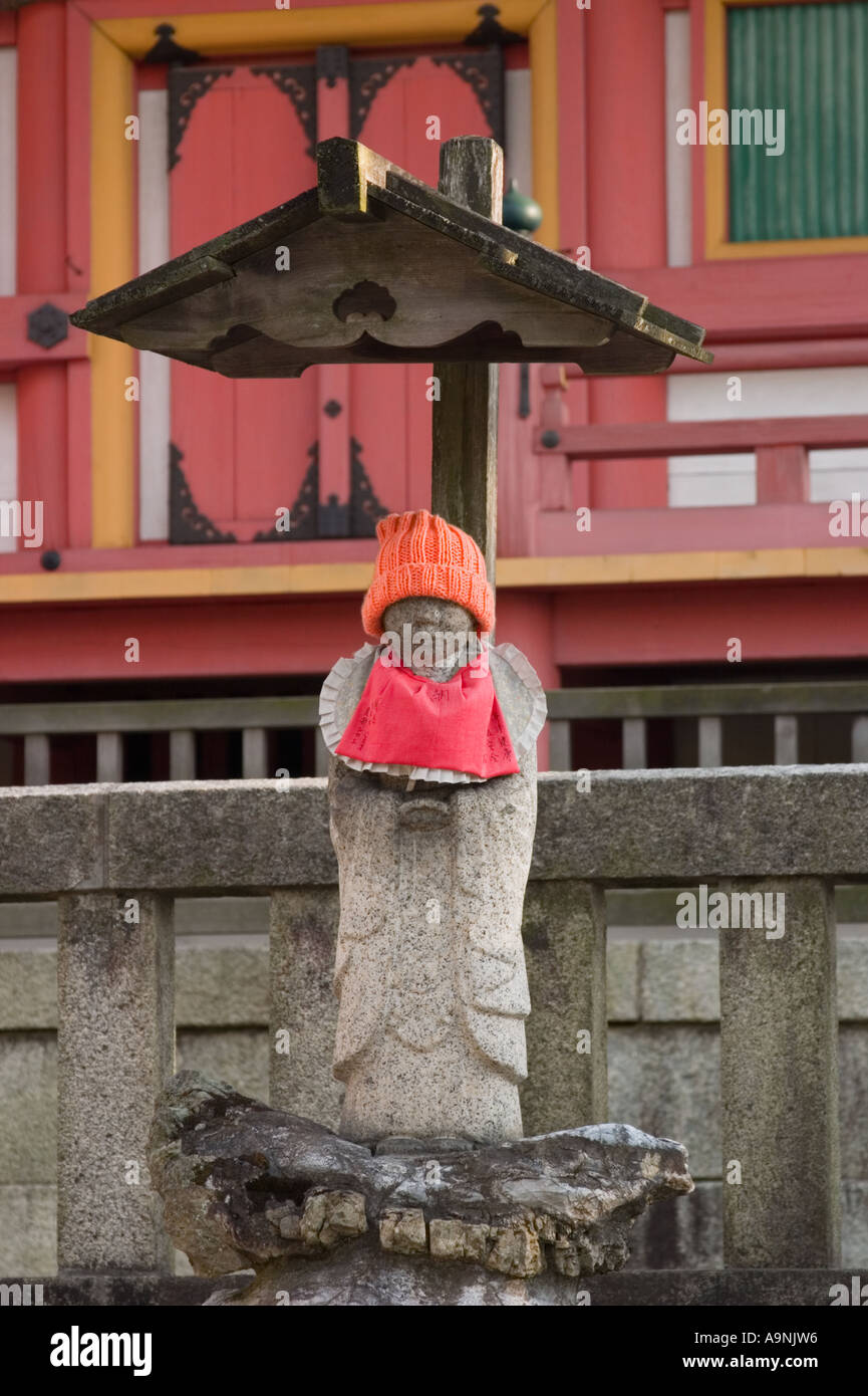 Jizo statue wearing an orange hat and bib at Kiyomizudera Temple