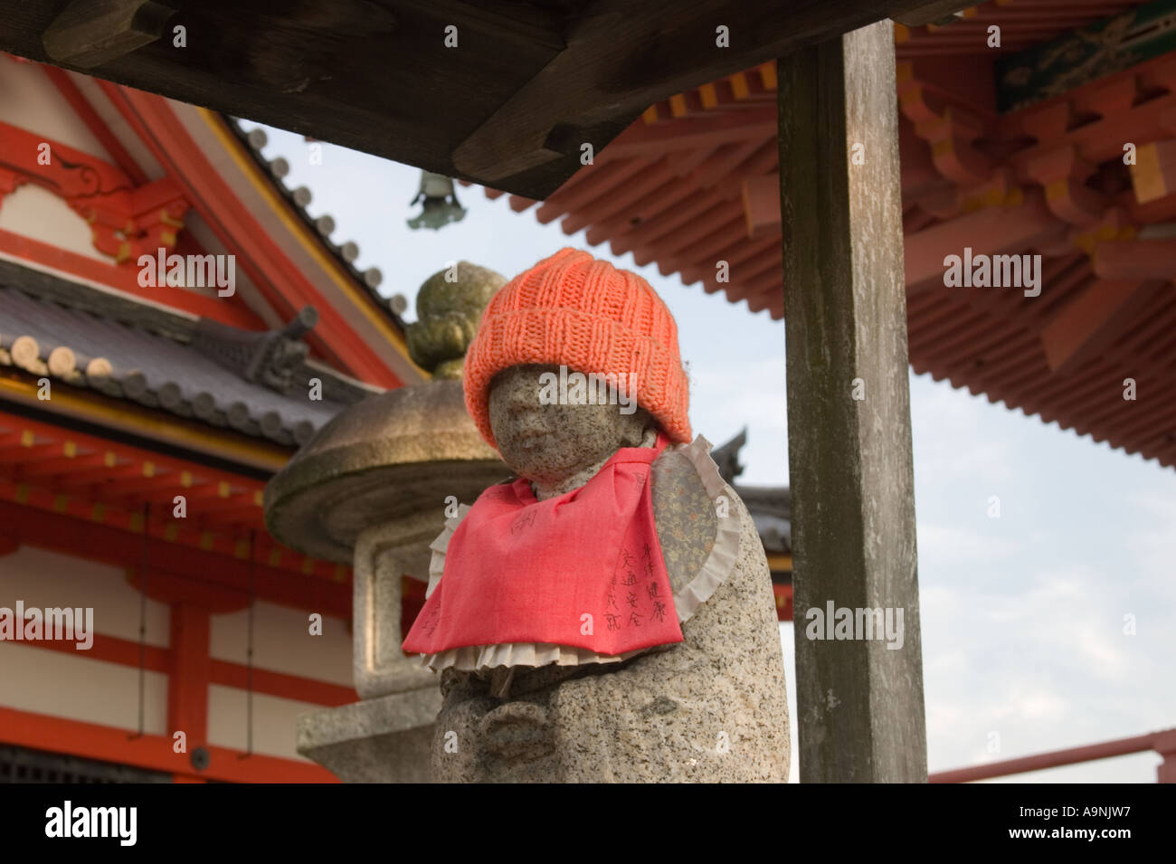 Buddhist Jizo statue wearing an orange hat and bib at Kiyomizudera