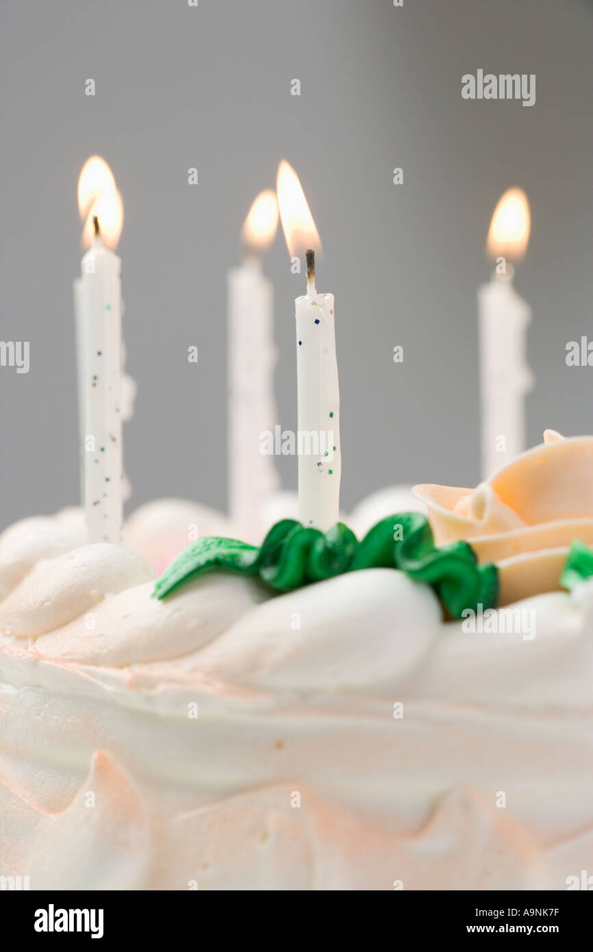 Lit candles on a birthday cake Stock Photo - Alamy