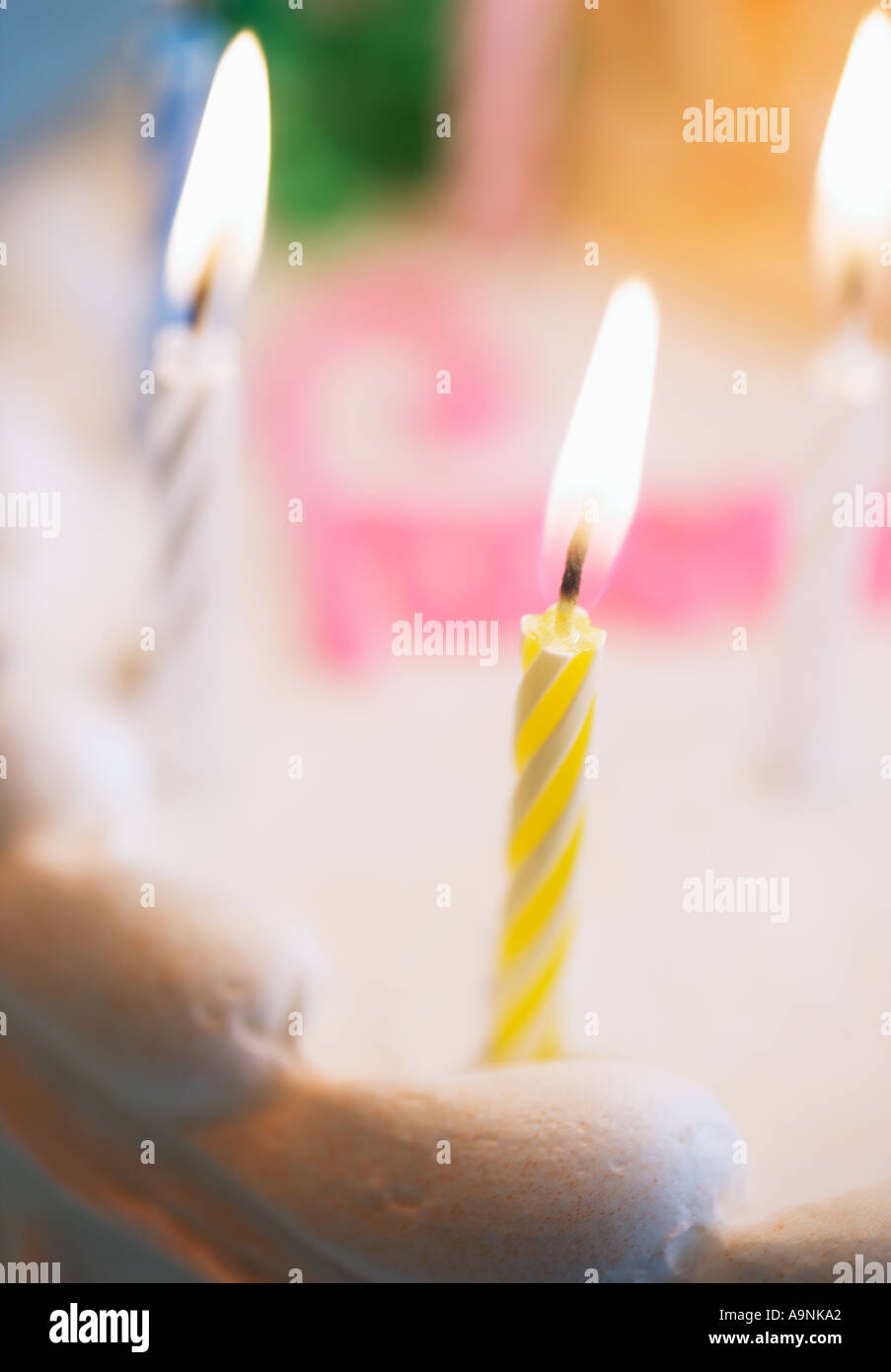 Lit candles on a birthday cake Stock Photo - Alamy