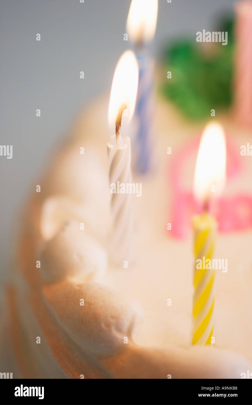 Lit candles on a birthday cake Stock Photo - Alamy