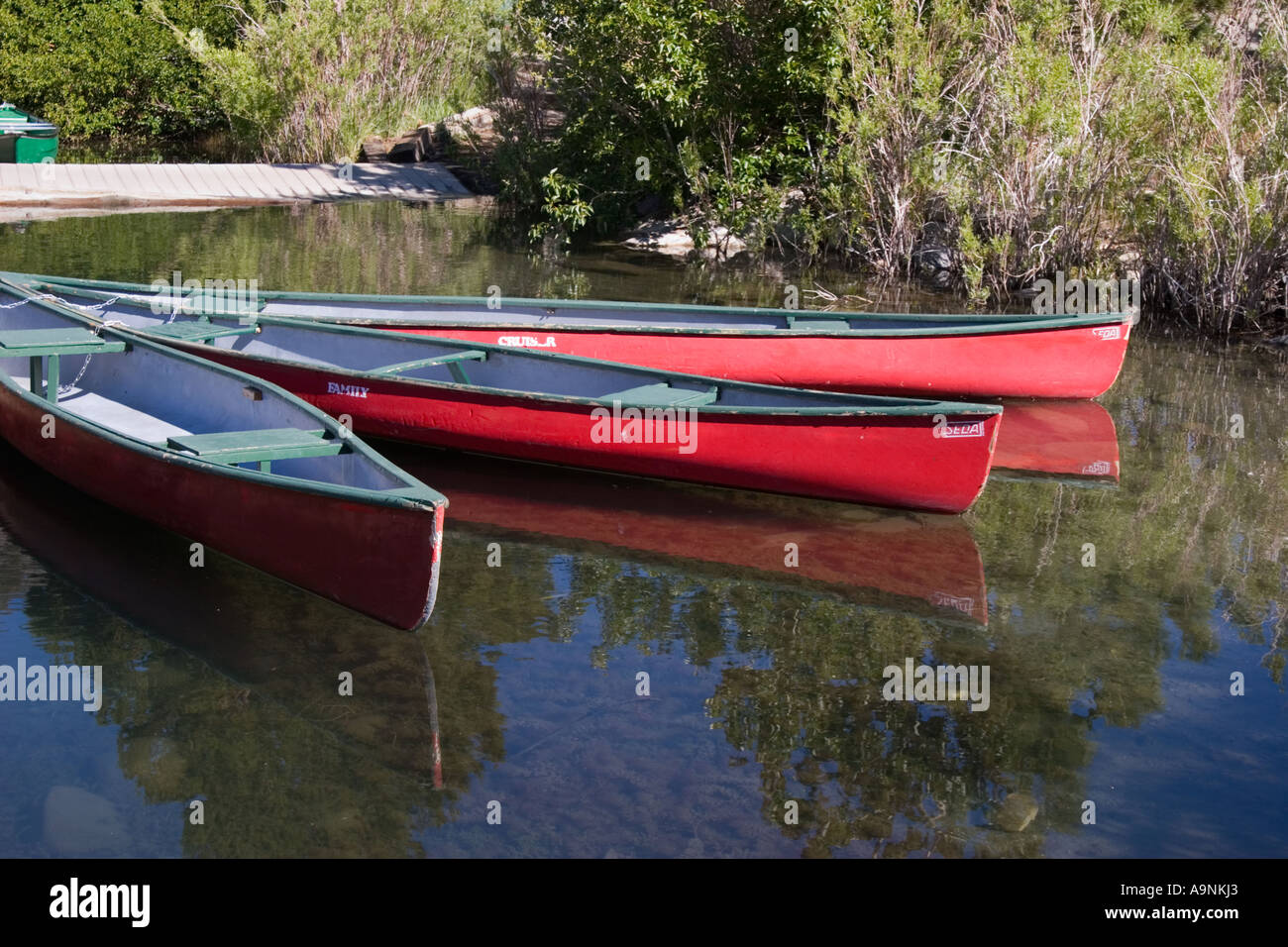 Canoes docked at the marina at Convict Lake Inyo National Forest California Stock Photo