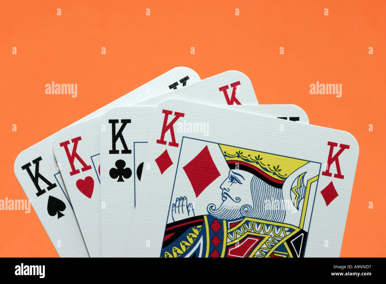 Close up of hand of 4 king playing cards kings four of a kind Stock