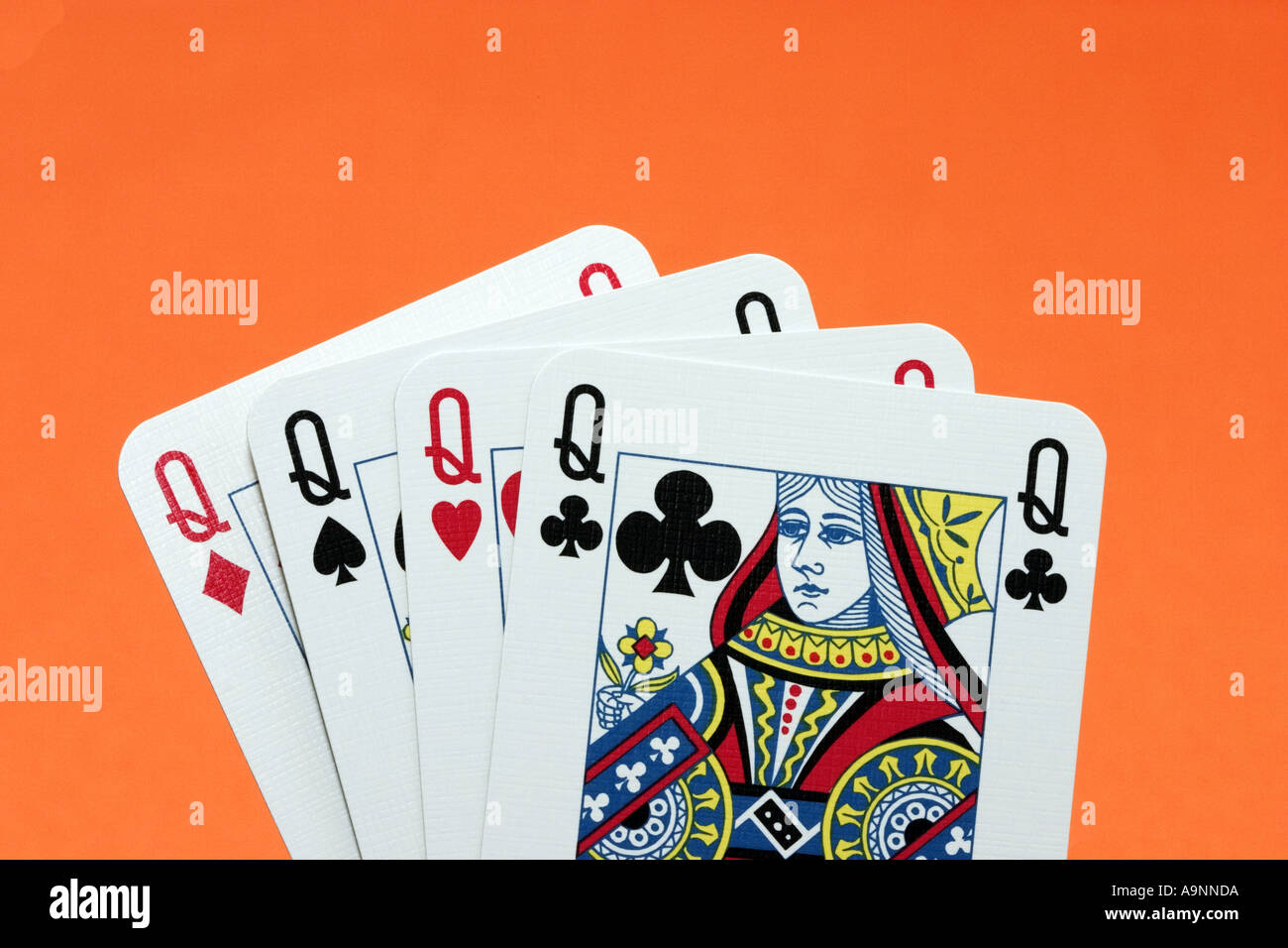 Close up of hand of 4 queen playing cards queens four of a kind Stock