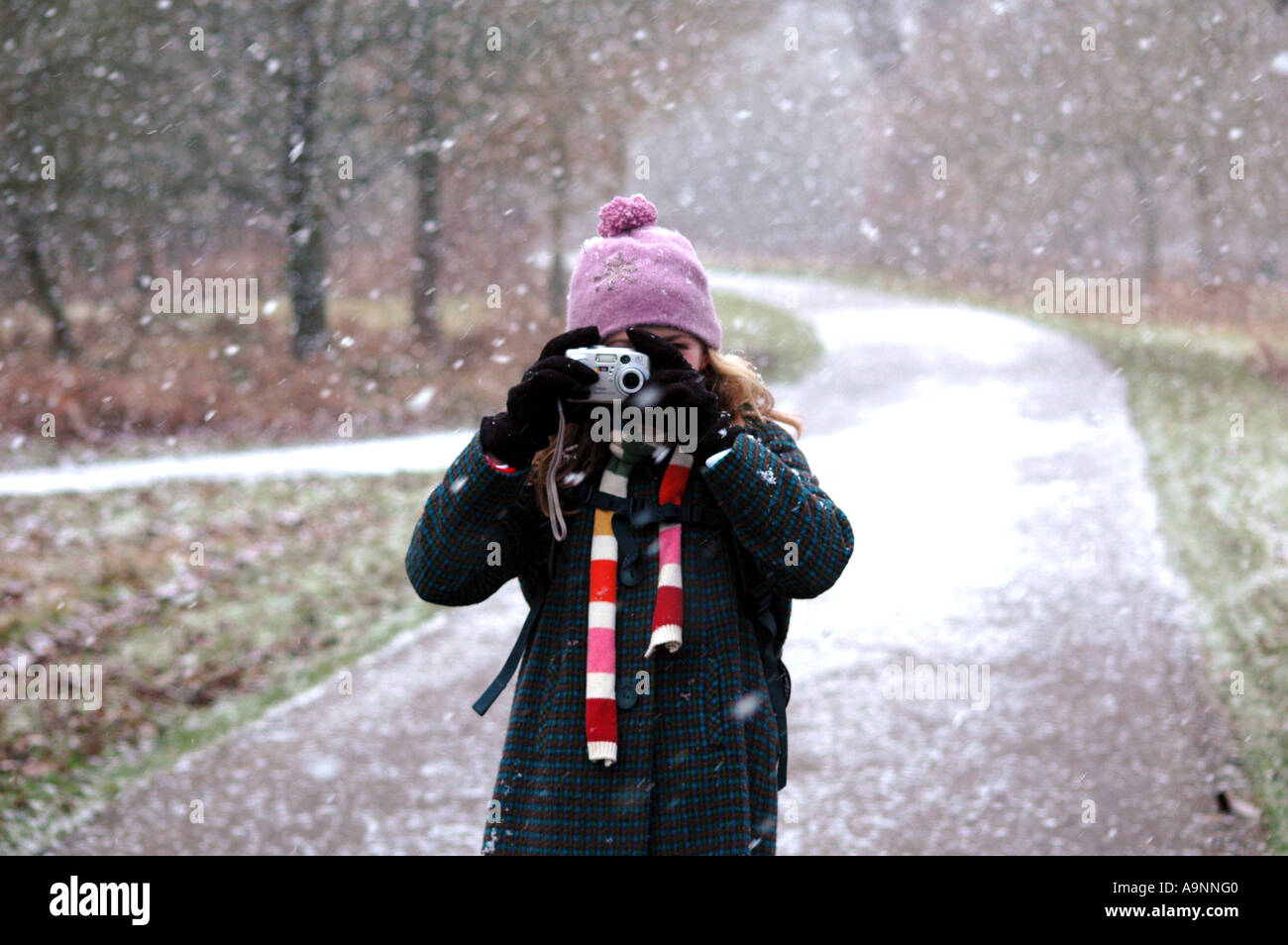 child taking a photograph in the snow picture Stock Photo