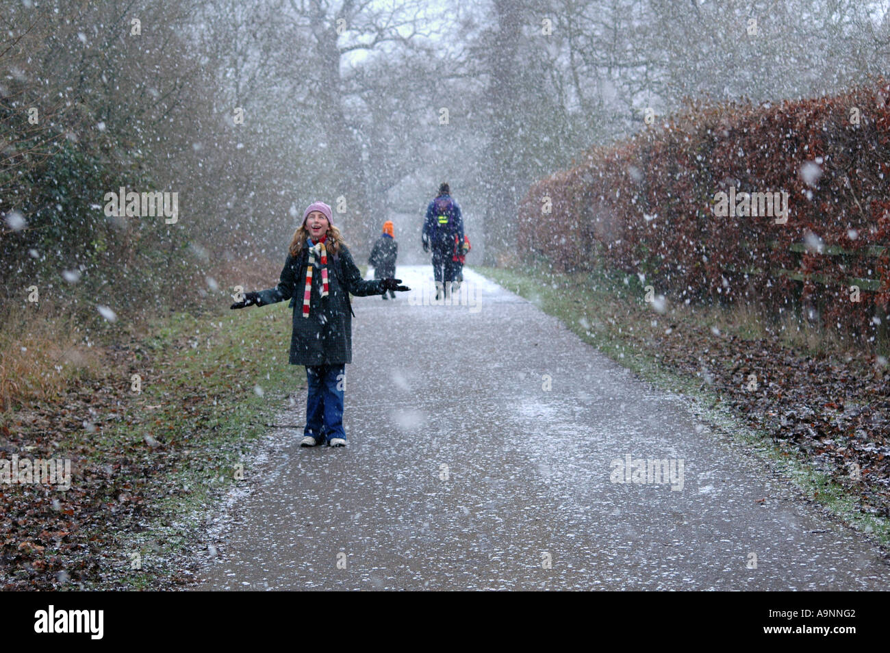 Family going for a walk in the snow Stock Photo