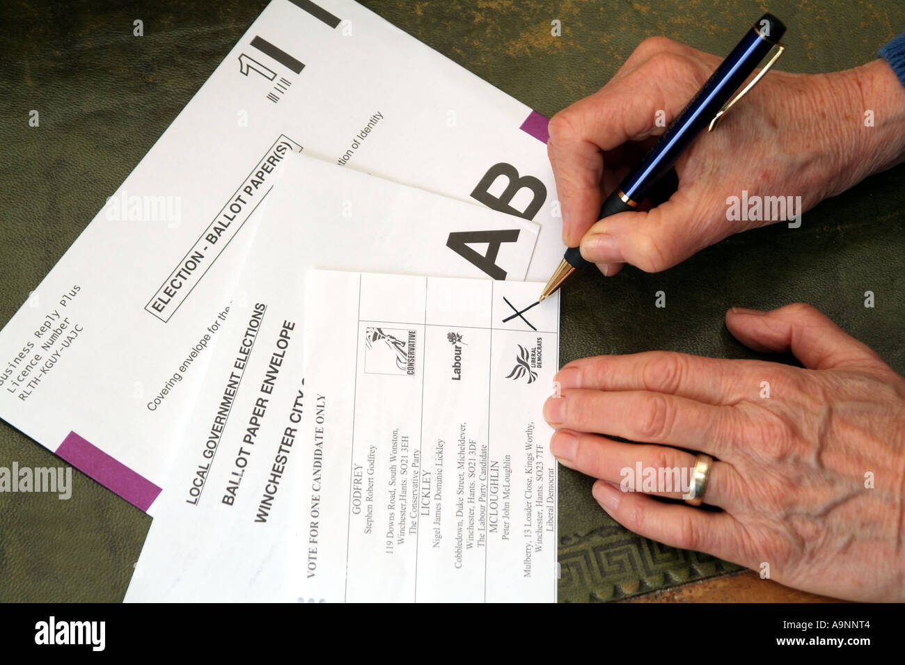 Completing a postal vote ballot paper. X cross marks the candidate selected. United Kingdom UK Stock Photo