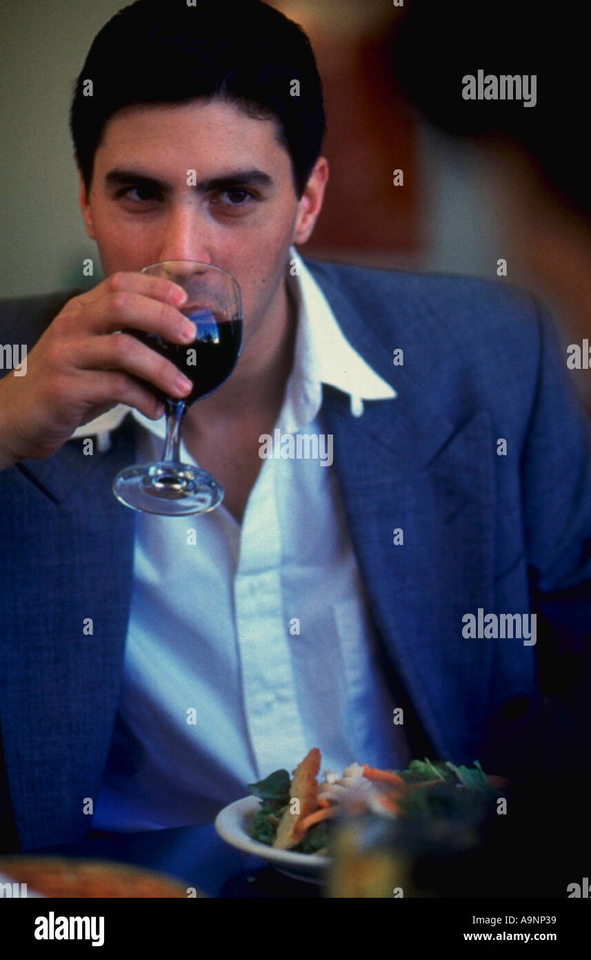 Man eating and drinking red wine in a restaurant Stock Photo - Alamy