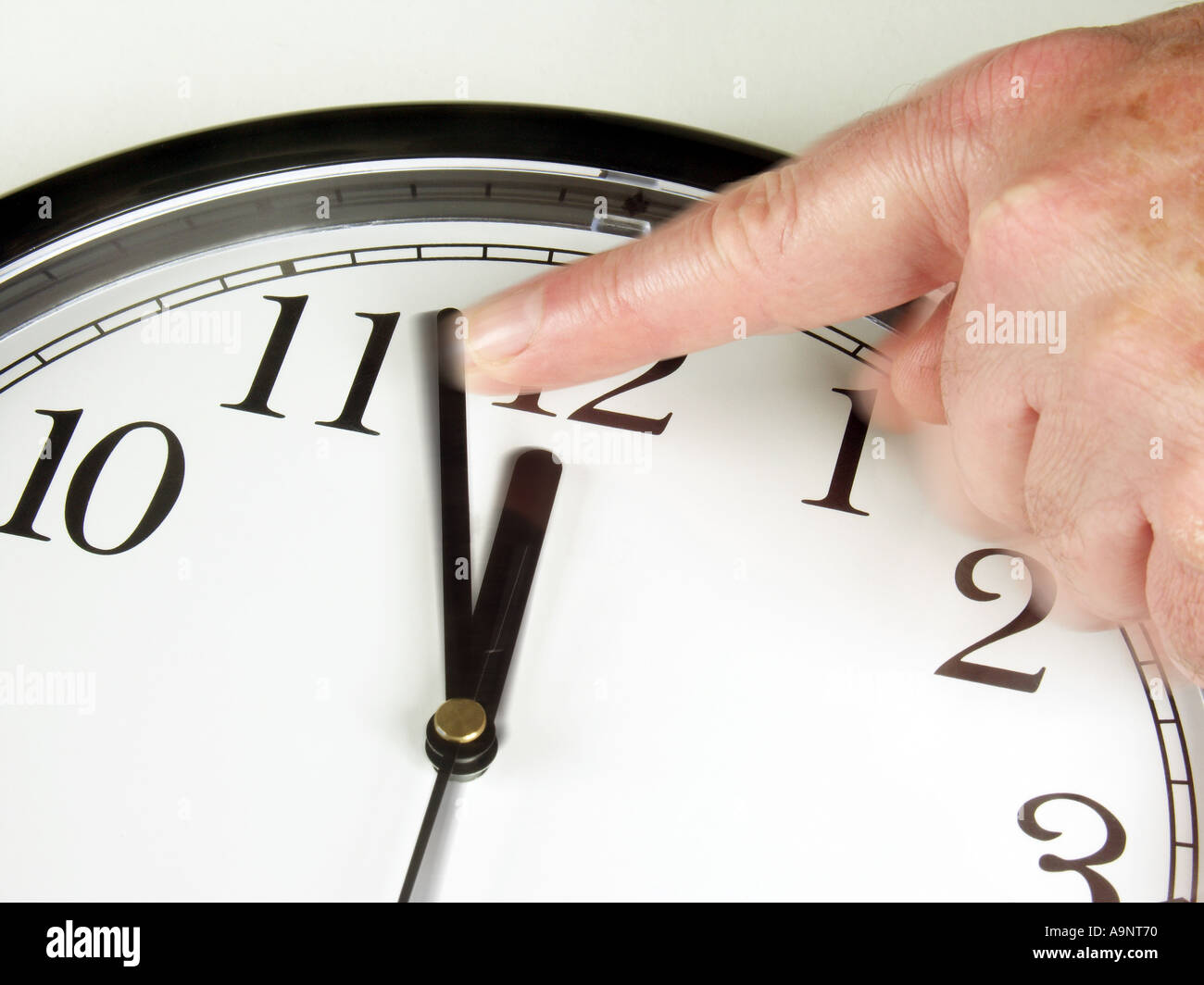 Finger trying to push time back Stock Photo Alamy