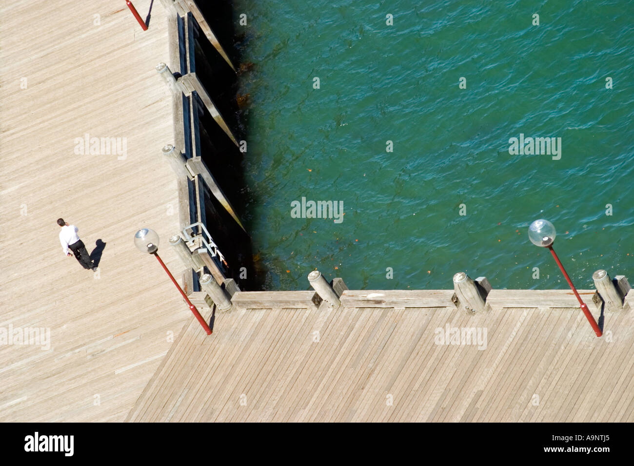 Man walks on decking as viewed form above The Rocks Sydney Stock Photo ...
