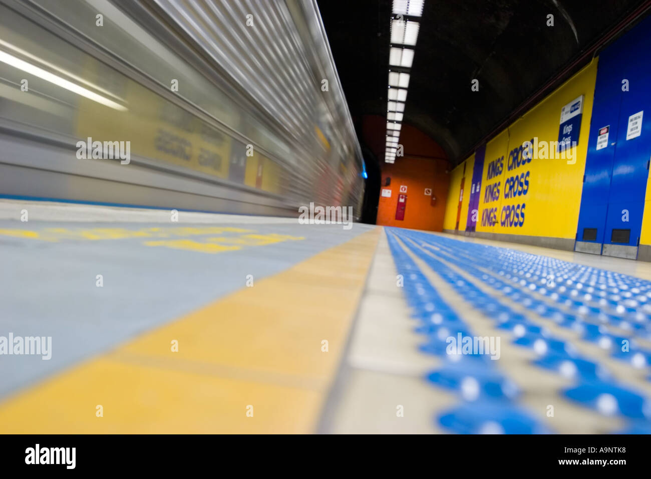 Speeding subway train arrives at Kings Sross station Sydney Stock Photo