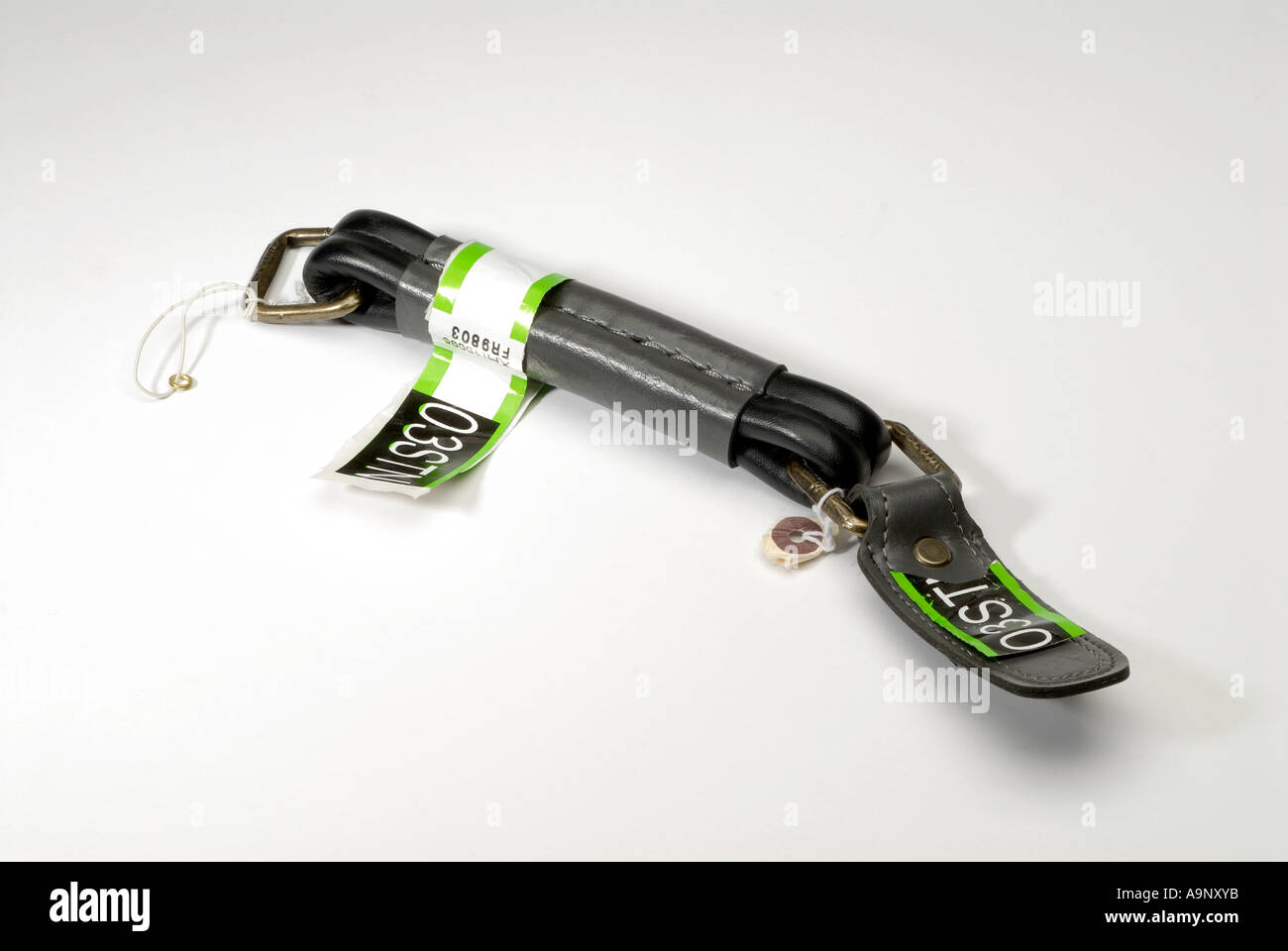 Suitcase handle missing from suitcase at an airport baggage reclaim belt. Stock Photo