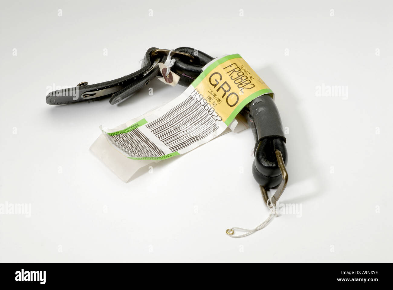 Suitcase handle missing from suitcase at an airport baggage reclaim belt. Stock Photo