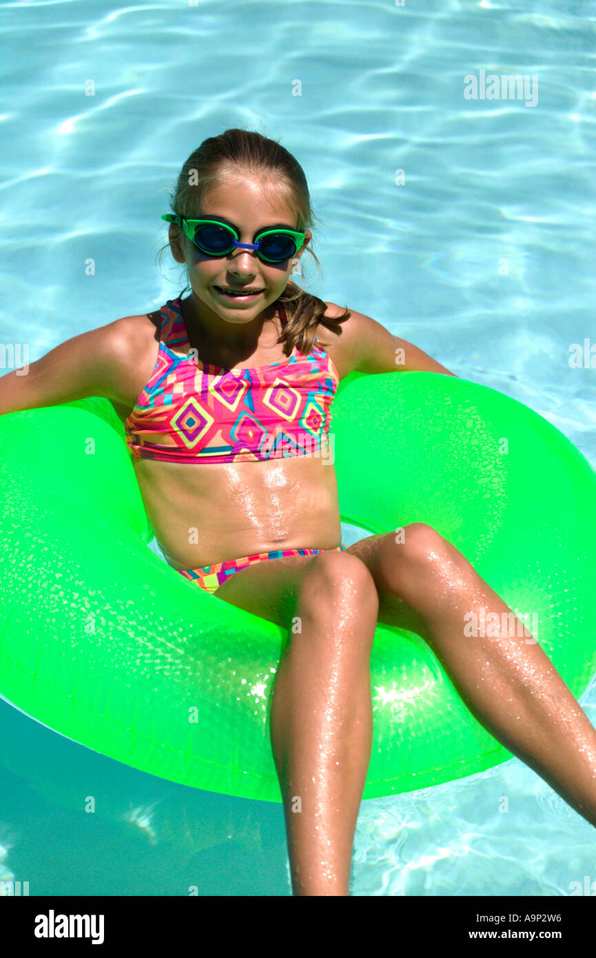 Girl in inner tube in swimming pool Stock Photo Alamy
