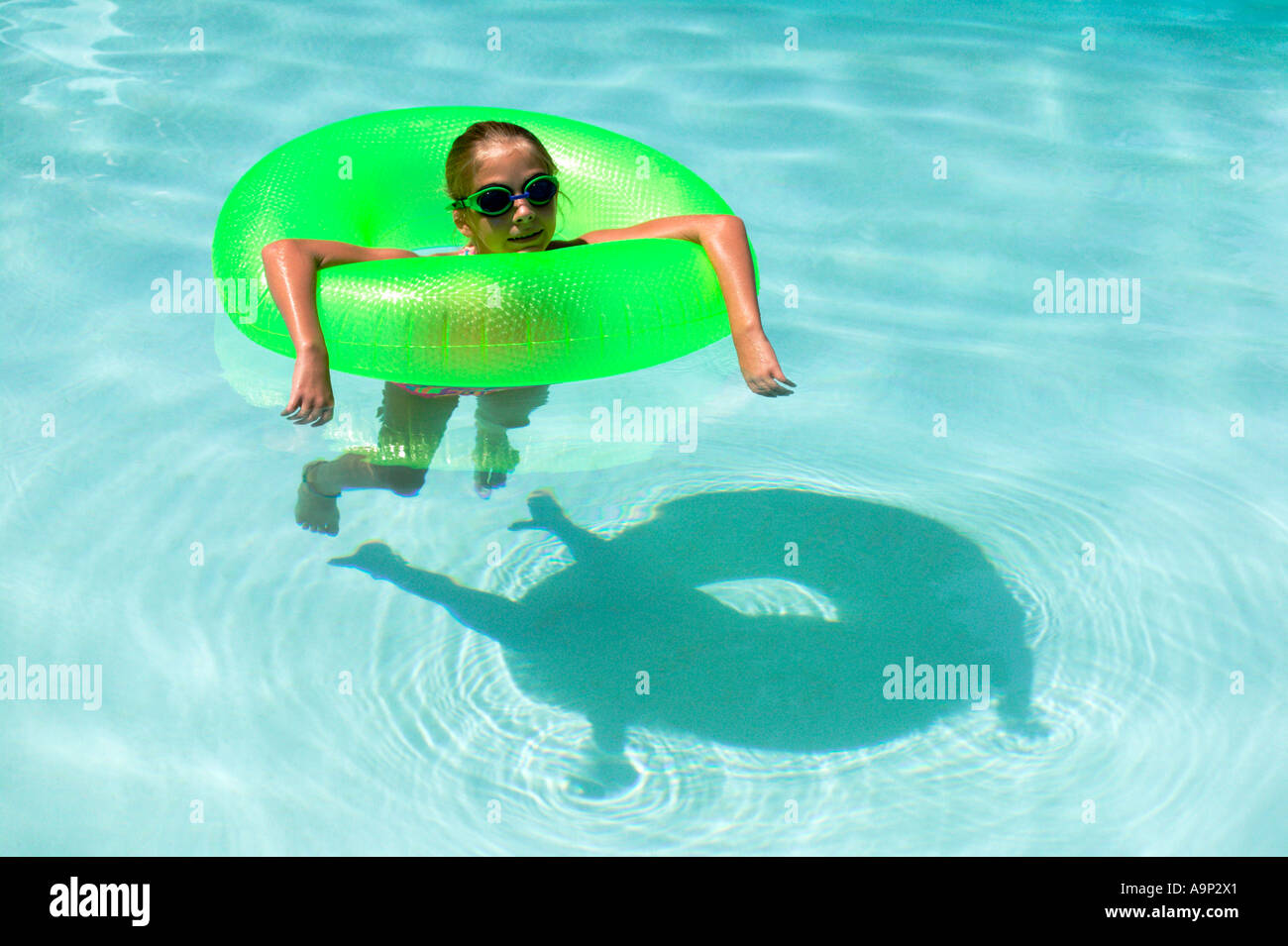Girl floating in inner tube with shadow Stock Photo Alamy