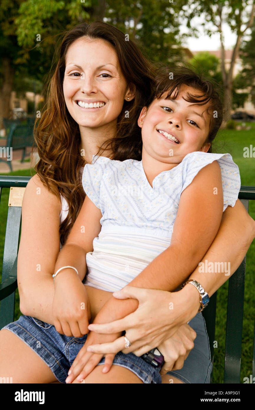 Mother and daughter sitting in a park Stock Photo