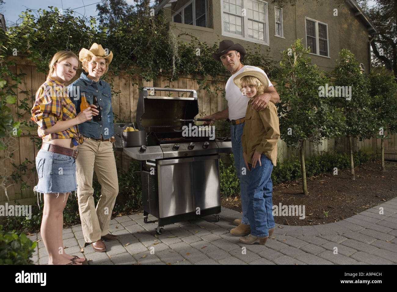 Portrait of a family standing near barbeque grill Stock Photo