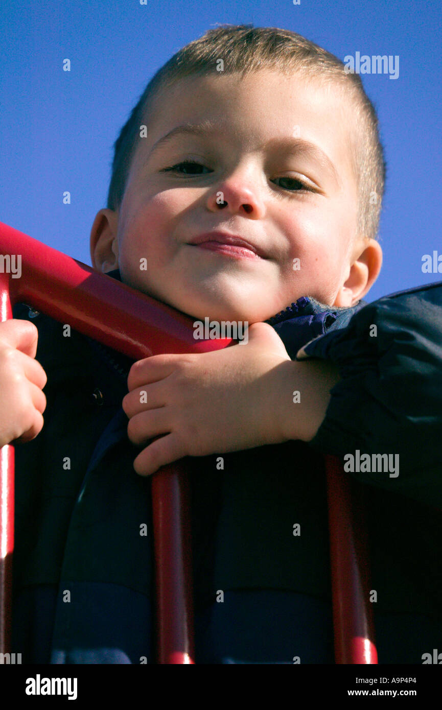 Resting On Railing Closeup of little boy resting on railing Stock Photo - Alamy