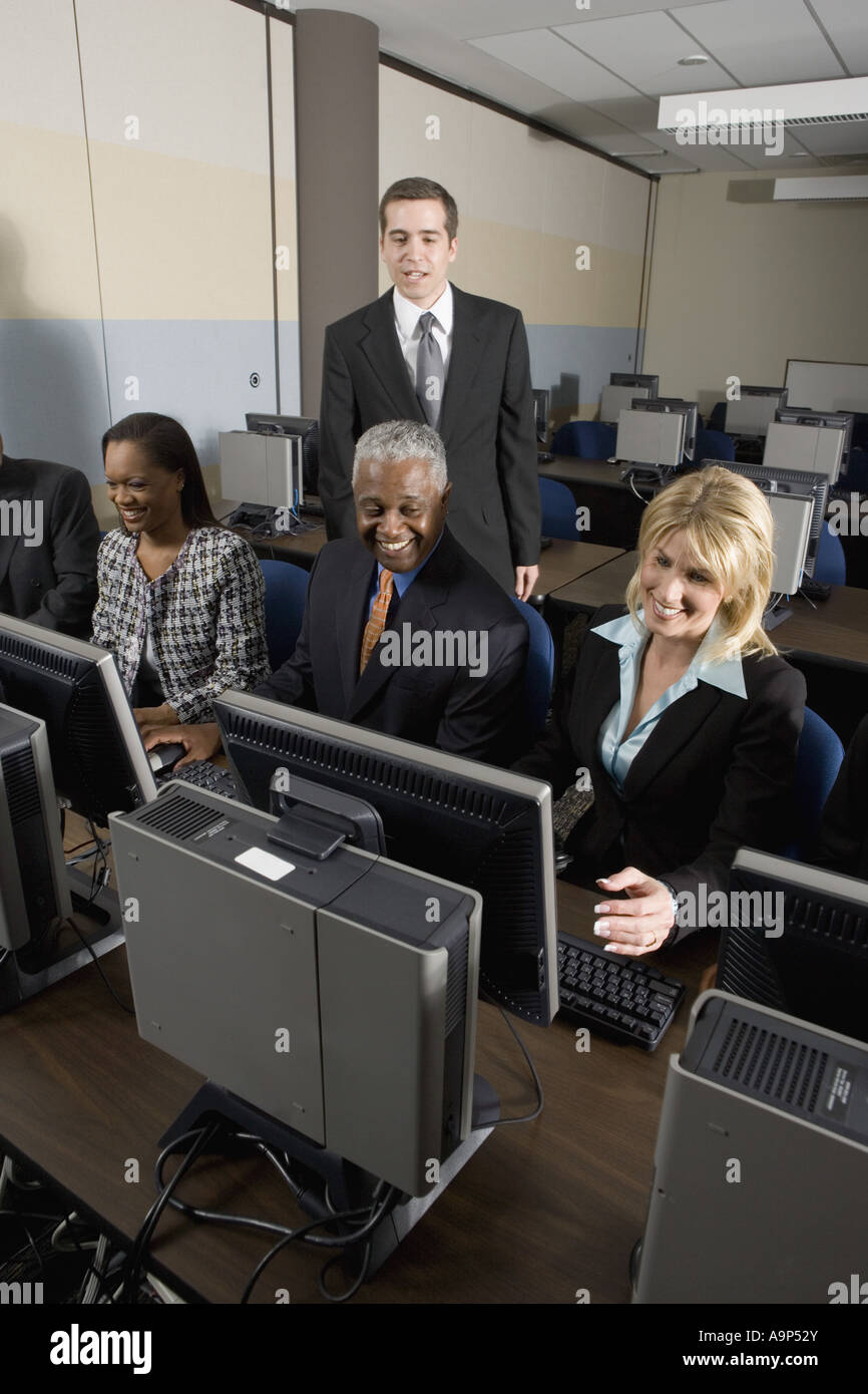 Colleague Computer Business colleagues at a computer training seminar Stock Photo - Alamy