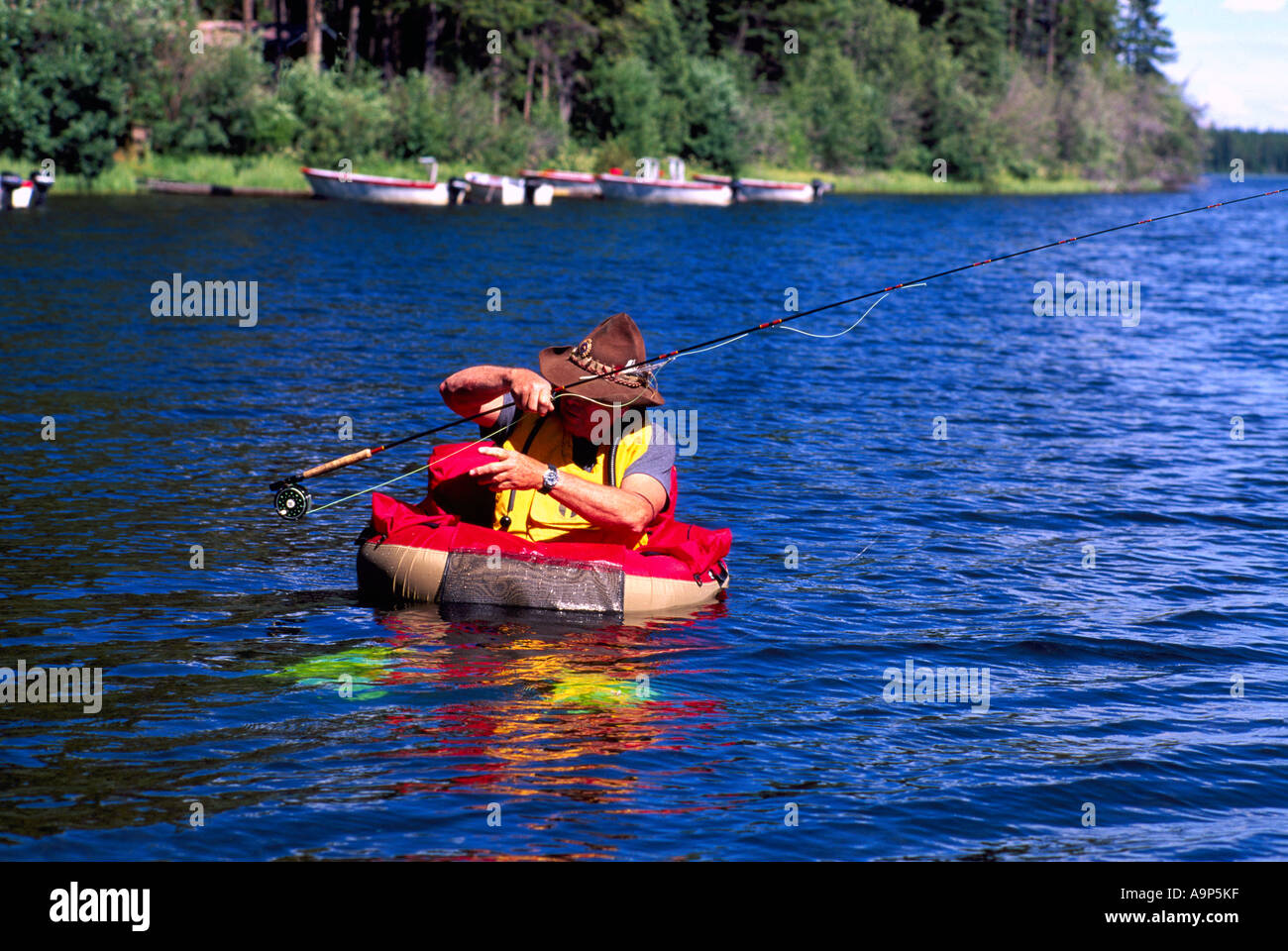 Fly Fisherman in a Belly Boat fishing for Trout in Hi Hium Lake in the