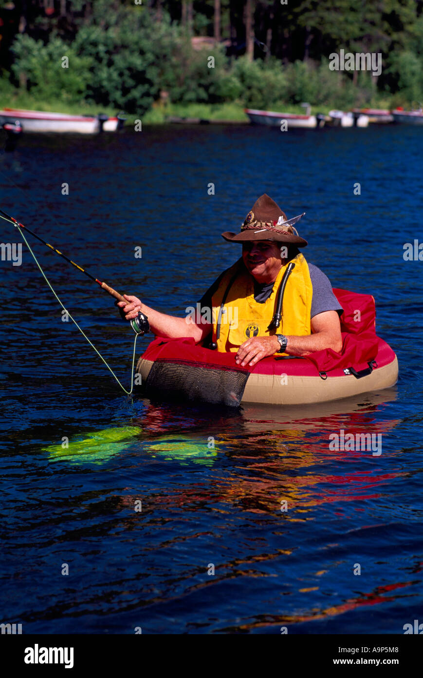 Fly Fisherman fishing for Trout while floating in a Belly Boat on Hi Hium  Lake, Cariboo Region, BC, British Columbia, Canada Stock Photo - Alamy