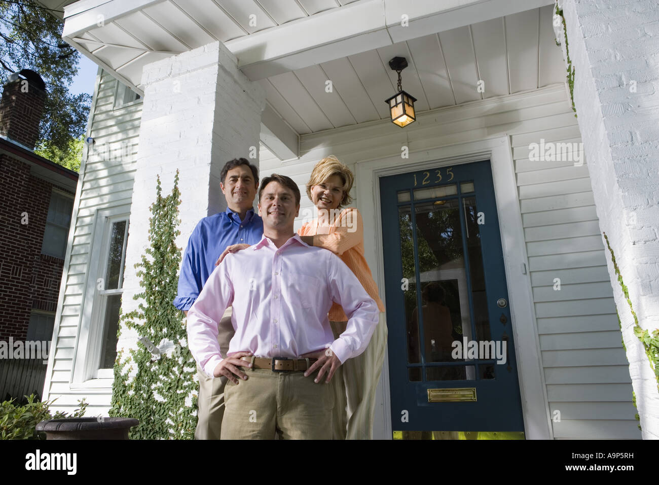 Portrait of a family standing outside a house Stock Photo - Alamy