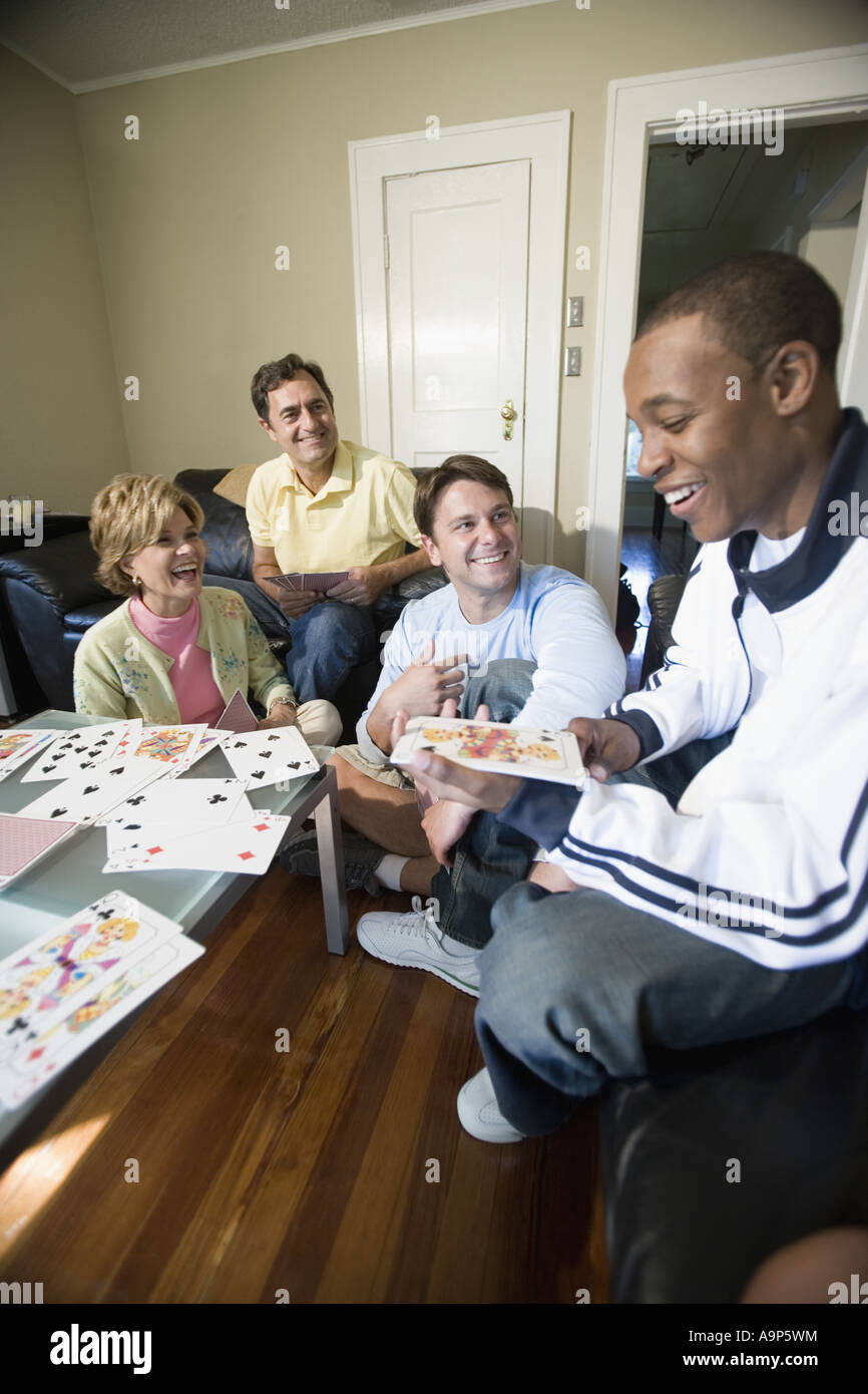 People playing cards in a living room Stock Photo - Alamy