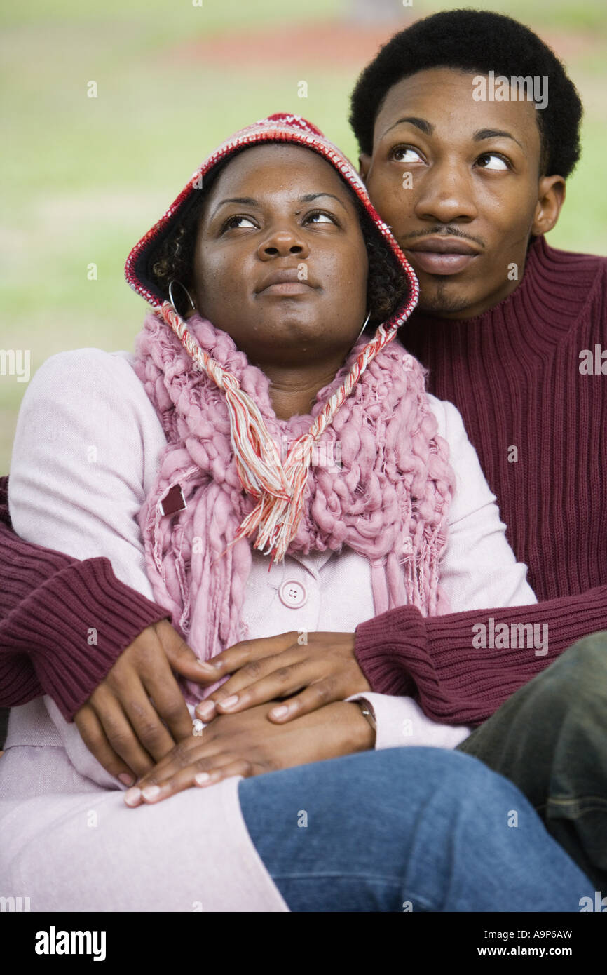 Young couple sitting together and embracing Stock Photo