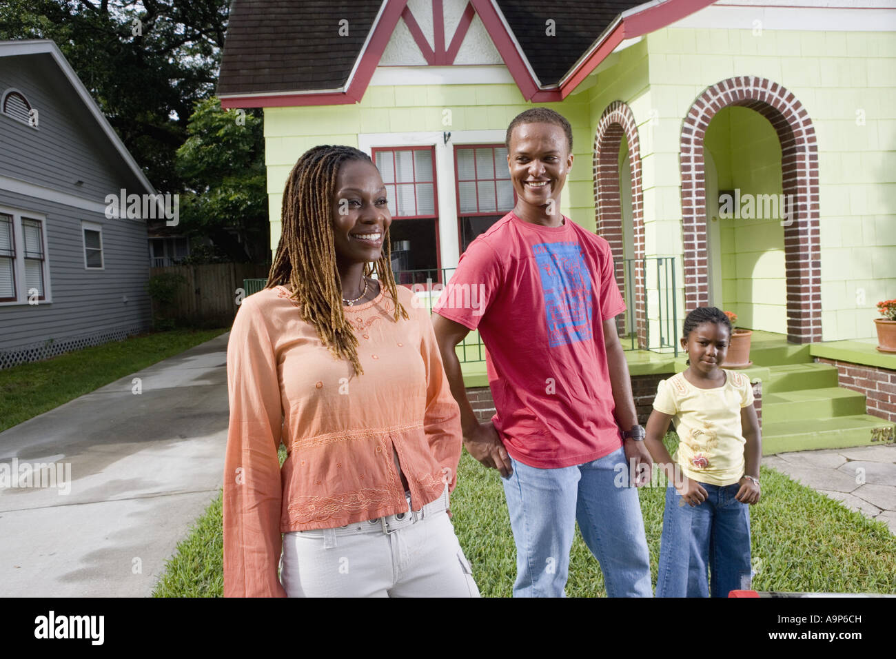 Portrait of family standing outside house Stock Photo Alamy