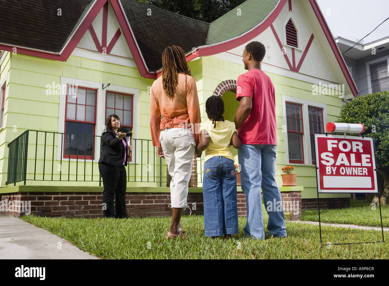 Real estate broker showing house to buyers Stock Photo Alamy