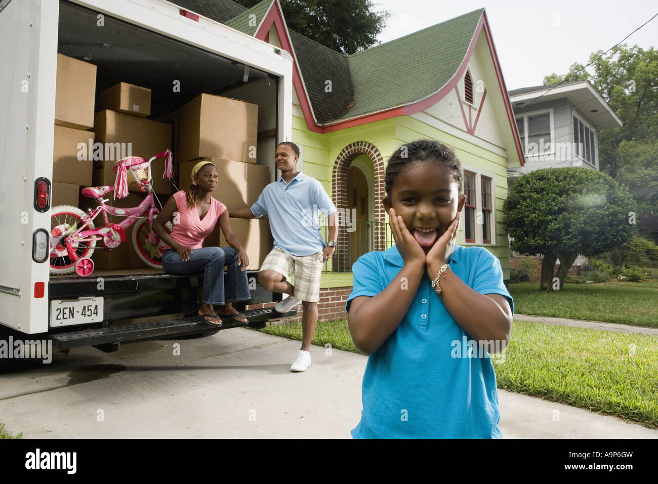 Portrait of a family standing outside a house by moving truck Stock ...