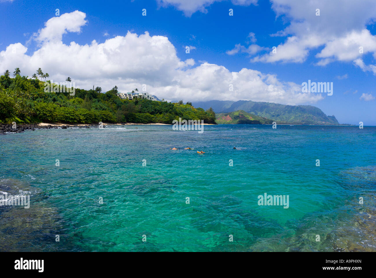 Snorkelers in a cove near Hideaways Beach Princeville Island of Kauai