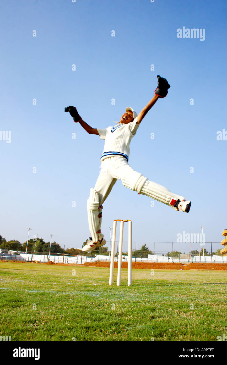 Wicket keeper jumping in jubilation Stock Photo
