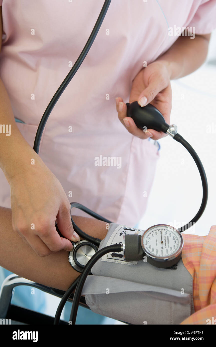 Nurse taking patients blood pressure Stock Photo Alamy