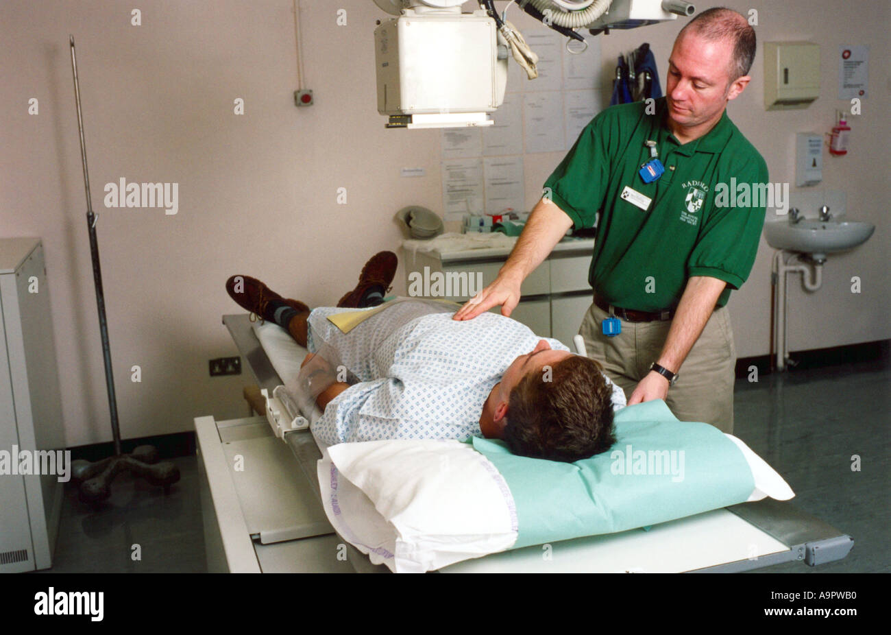 Radiographer preparing patient for x ray Stock Photo