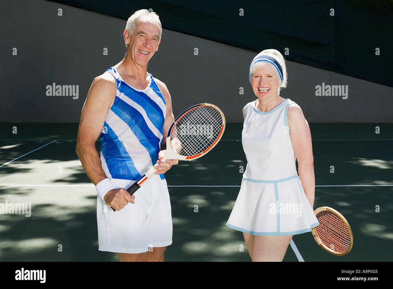 Senior couple on tennis court Stock Photo