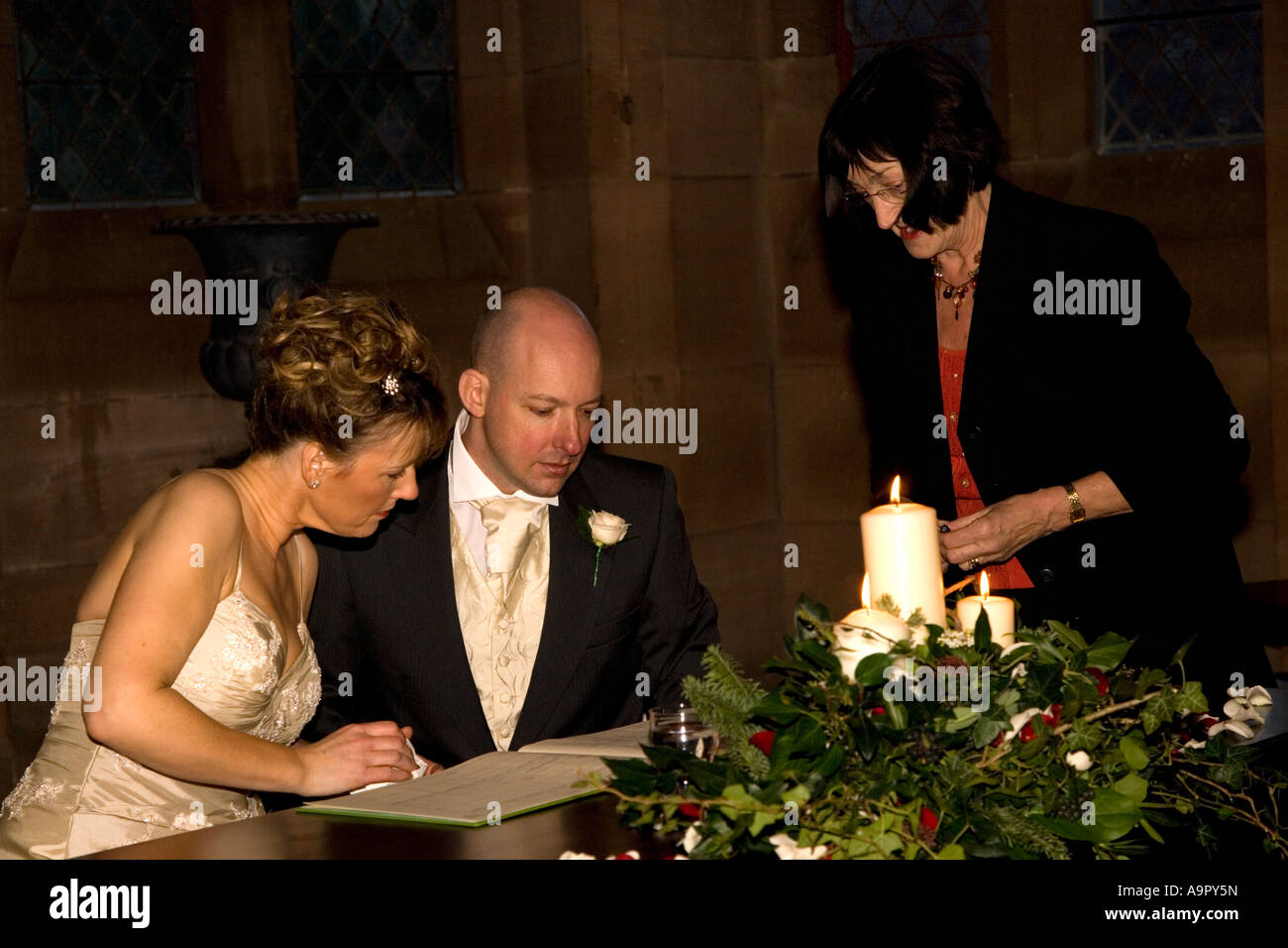 Bride and groom signing the register Stock Photo