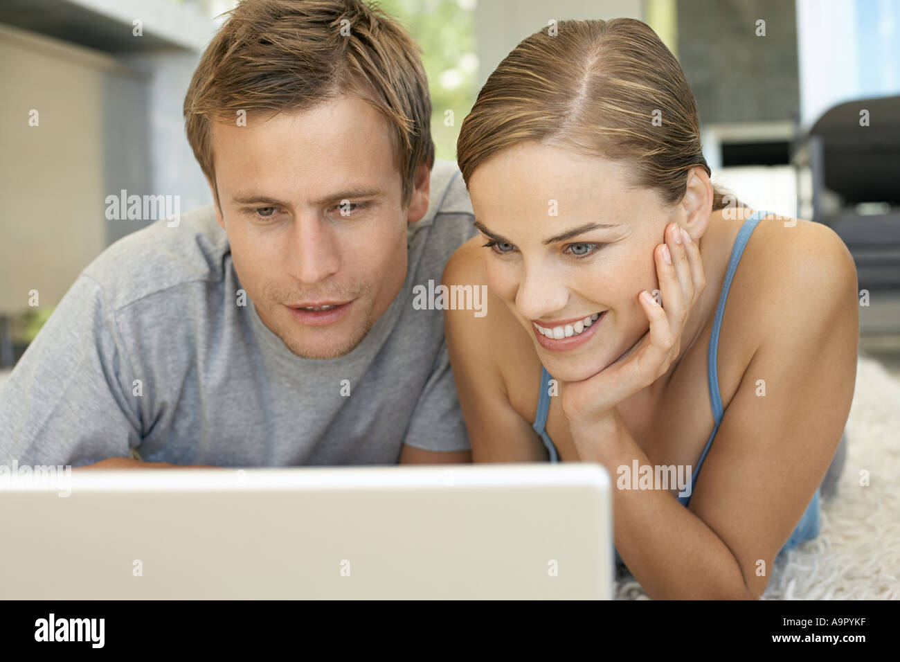 Mid adult couple using laptop Stock Photo