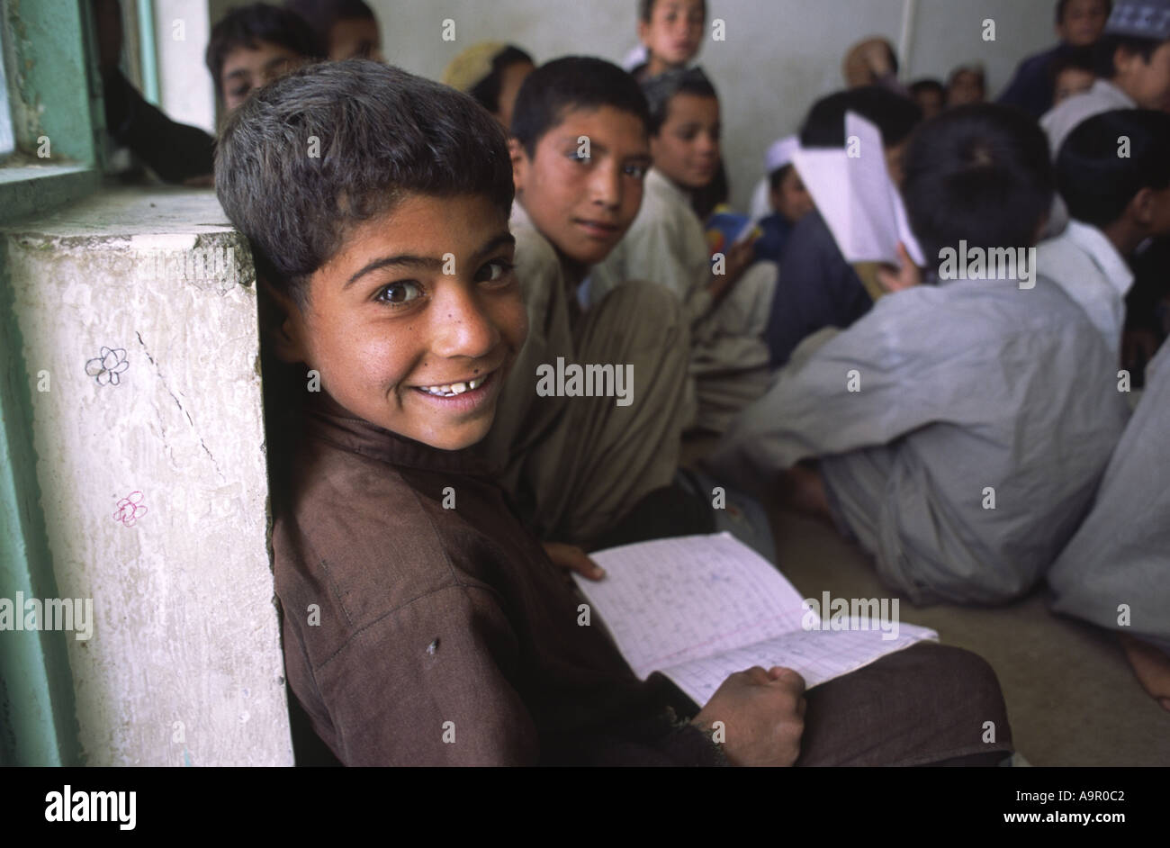 Young Afghan refugee children receiving a few hours basic education from an NGO funded project in Quetta Balochistan Pakistan Stock Photo