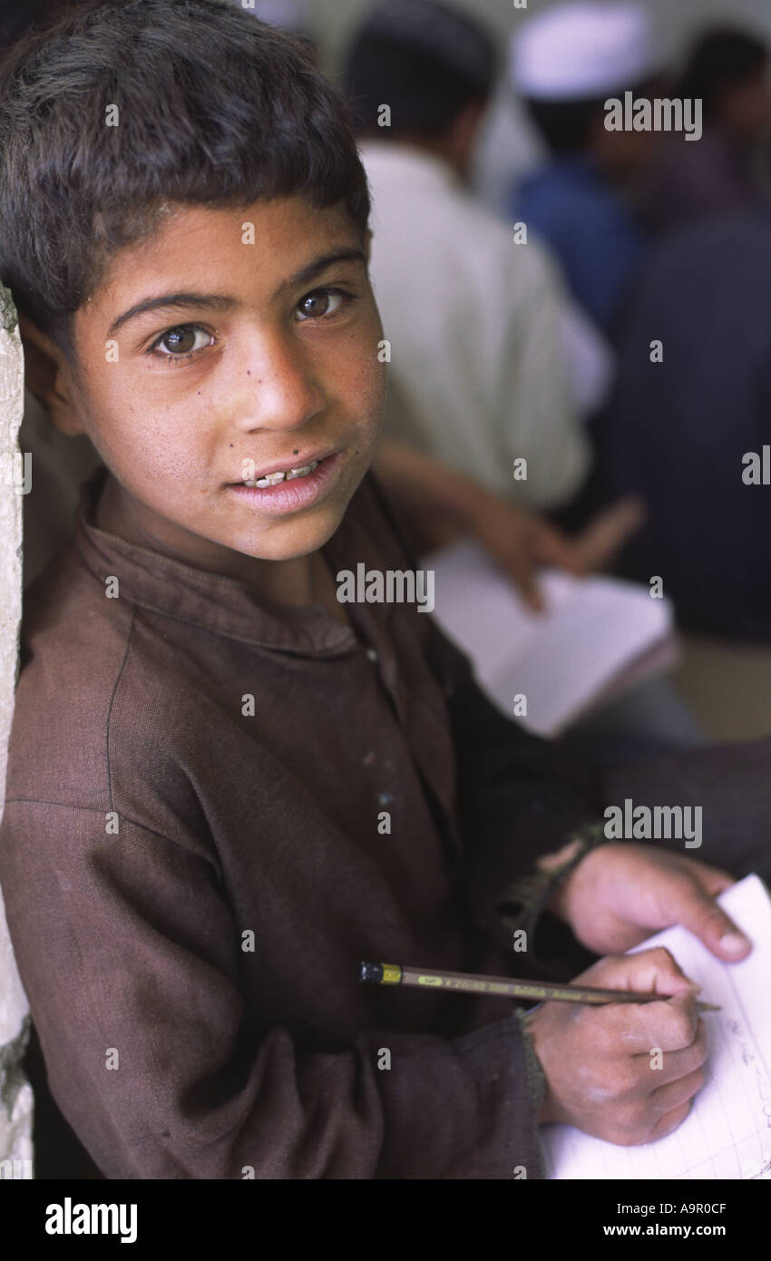 Young Afghan refugee children receiving a few hours basic education from an NGO funded project in Quetta Balochistan Pakistan Stock Photo