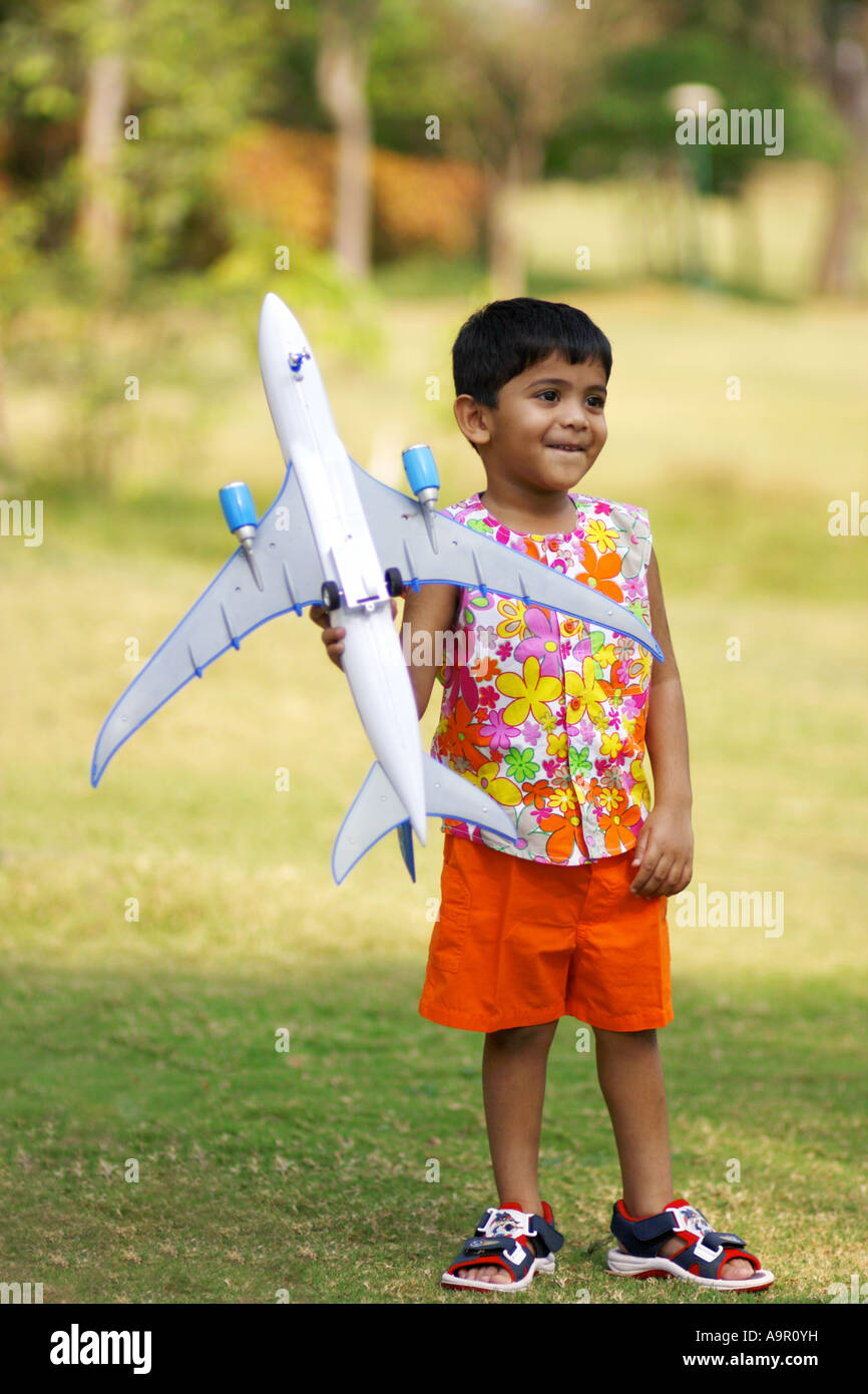Young boy playing with a toy airplane Stock Photo - Alamy