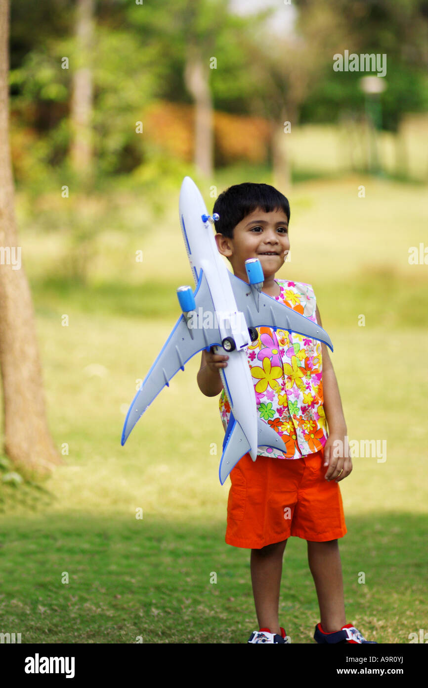 Young boy playing with a toy airplane Stock Photo - Alamy