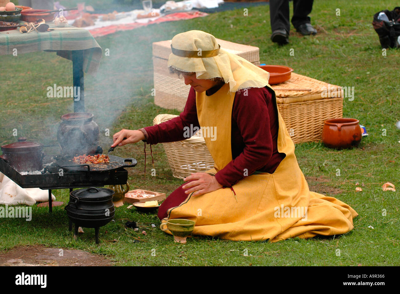 Medieval cook cooking outside on open fire at the annual Abergavenny