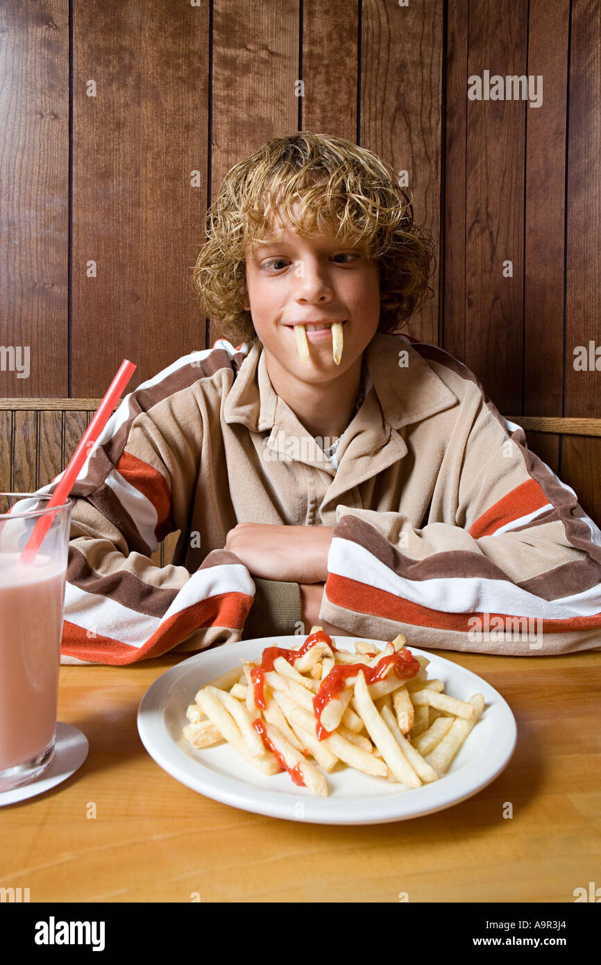 Teenage boy playing with his food Stock Photo Alamy